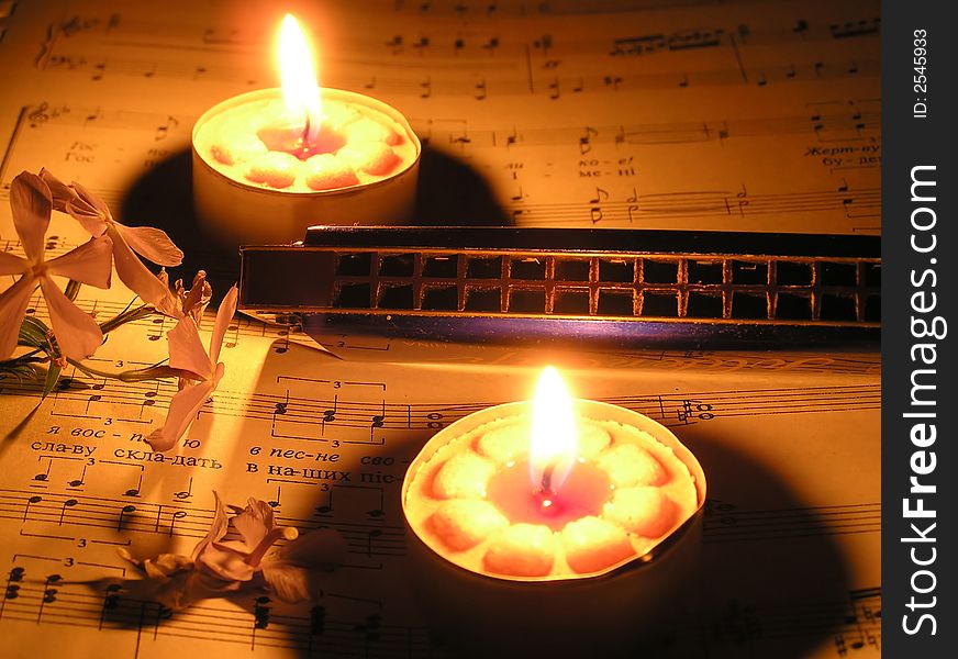 Harmonic and flowers and candle on note paper