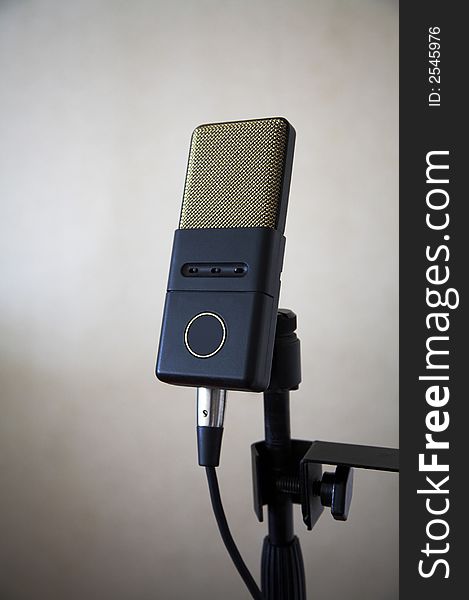 Modern microphone on a rack in musical studio