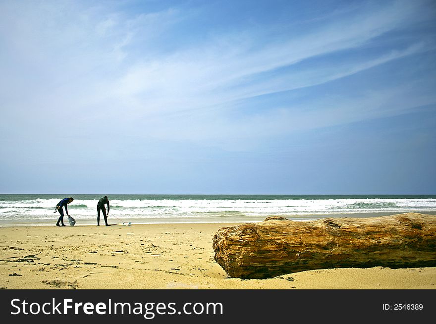 A photo of a big blue sky in the beach with two surfers and a trunk. A photo of a big blue sky in the beach with two surfers and a trunk.