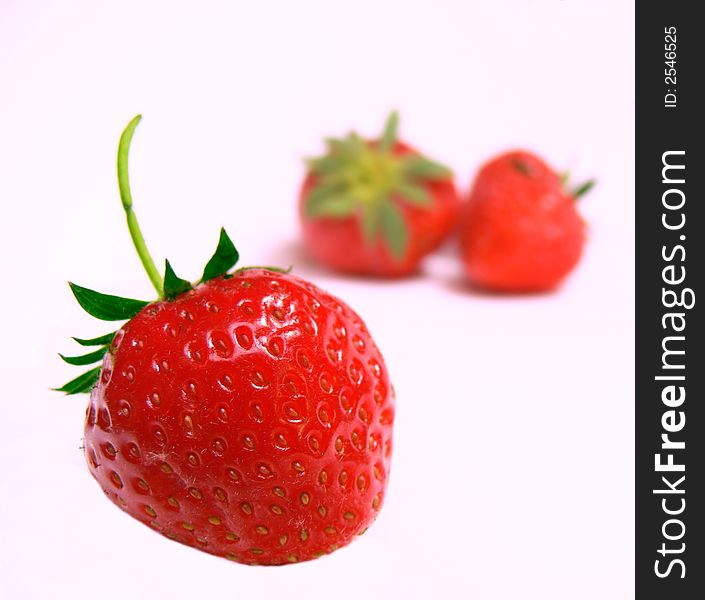 The strawberries on a white background.