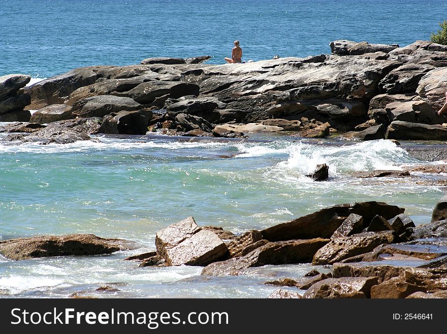 Woman Meditating At The Beach