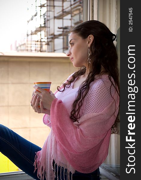 Beautiful young woman enjoying in moment with hot drink. Beautiful young woman enjoying in moment with hot drink