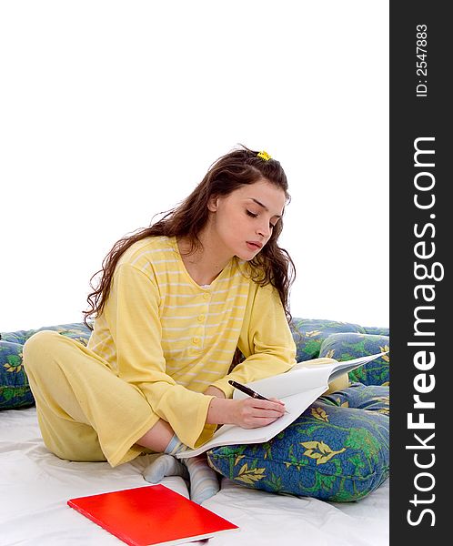 Beautiful young woman in pajamas study in bed. Beautiful young woman in pajamas study in bed