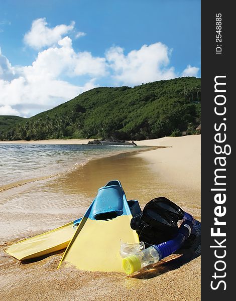 Image of sandy beach with snorkle, eye goggles and flippers. Image of sandy beach with snorkle, eye goggles and flippers