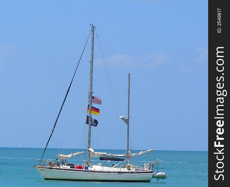 This boat was flying its pirate flag off the Florida Gulf Coast as people relaxed on the beach. This boat was flying its pirate flag off the Florida Gulf Coast as people relaxed on the beach.