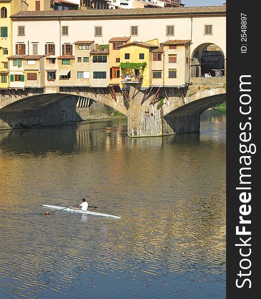Sculling in the Arno near Ponte Vecchio, Florence, Italy. Sculling in the Arno near Ponte Vecchio, Florence, Italy
