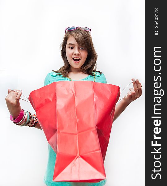 Teen girl with gift bags looking inside