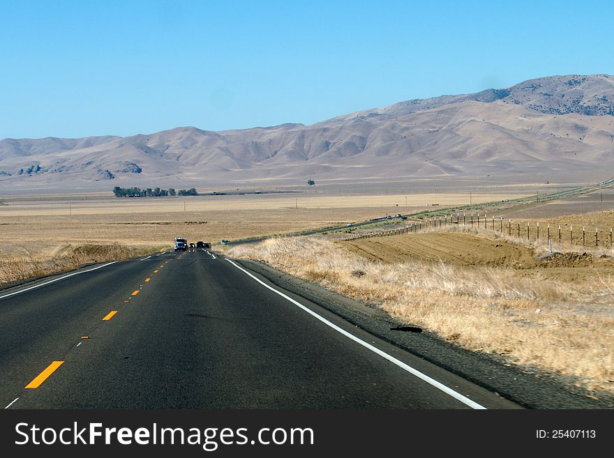 Mountain desert landscape with freeway in California