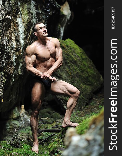 Bodybuilder in a cave