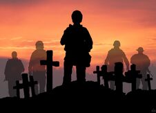 A Soldier In The Dying Day Is Standing On The Grave Of His Dead Friends. Stock Photo