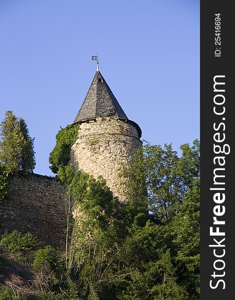 Tower with a piece of fortification for green trees. Tower with a piece of fortification for green trees