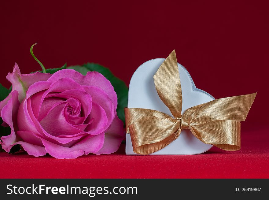 Heart shaped gift box with  pink rose