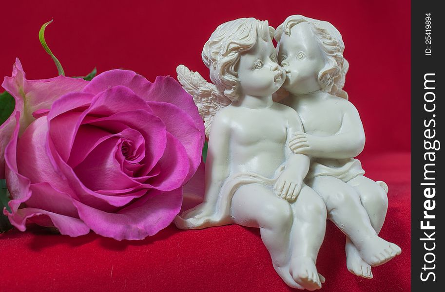 Angels kissing with pink rose. Angels kissing with pink rose