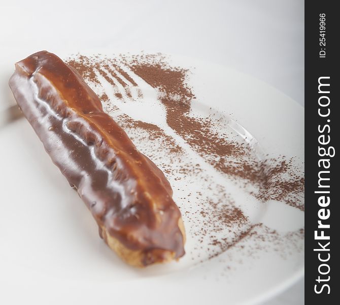Eclair on a white saucer