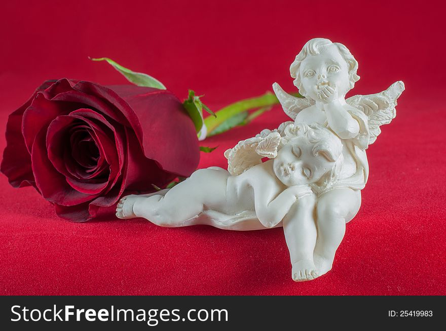 Angels with red rose on red background