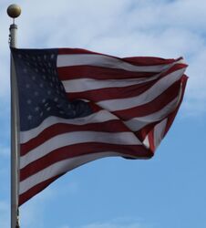 Patriotic American Flag At Baseball Field, Waving Freely Royalty Free Stock Photography