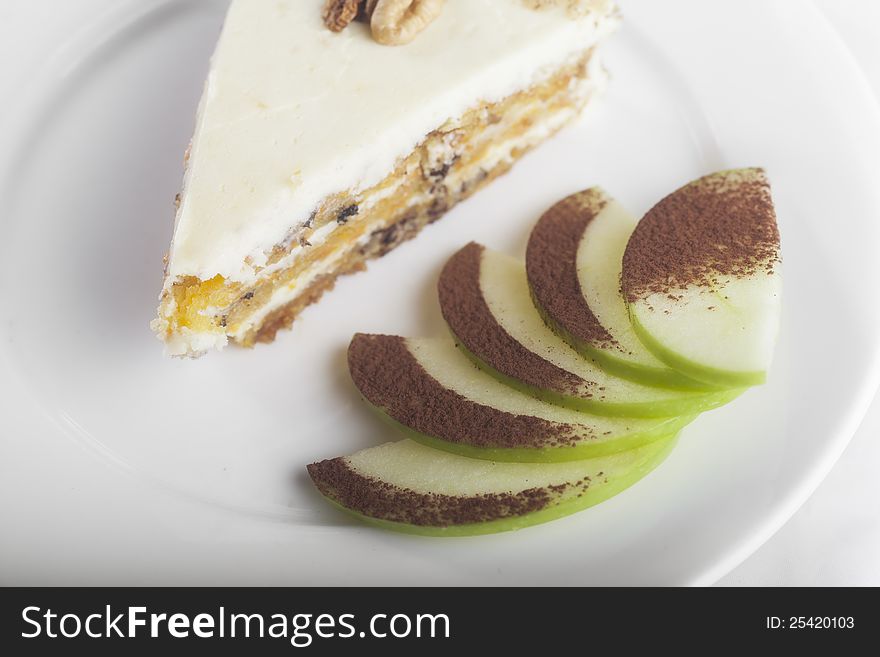 Cheesecake on a white plate with sliced apple