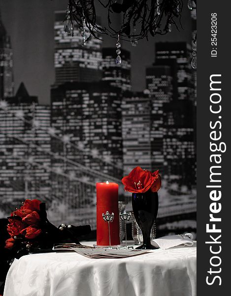 Luxury table set with Black and red color with blurry night city â€‹â€‹background. Goths wedding table set. Luxury table set with Black and red color with blurry night city â€‹â€‹background. Goths wedding table set.