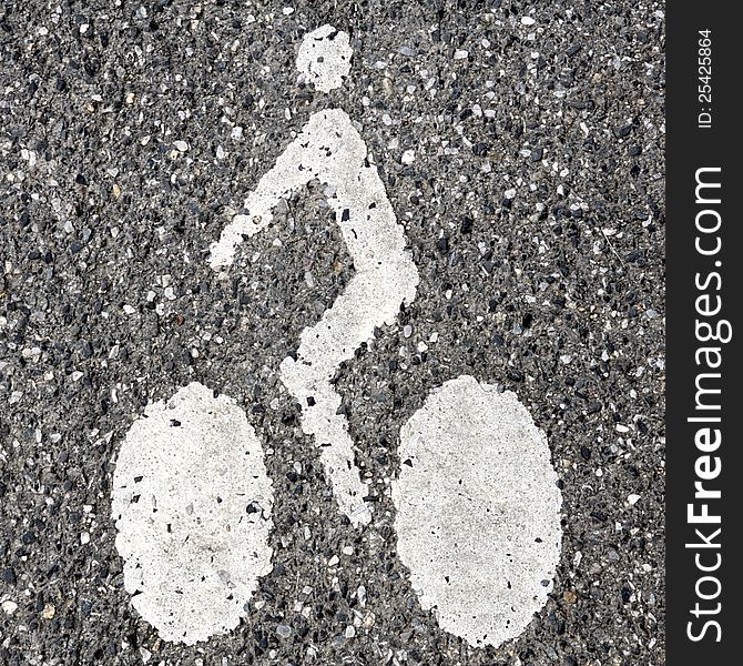 White sign on a cycle lane on a gray asphalt background