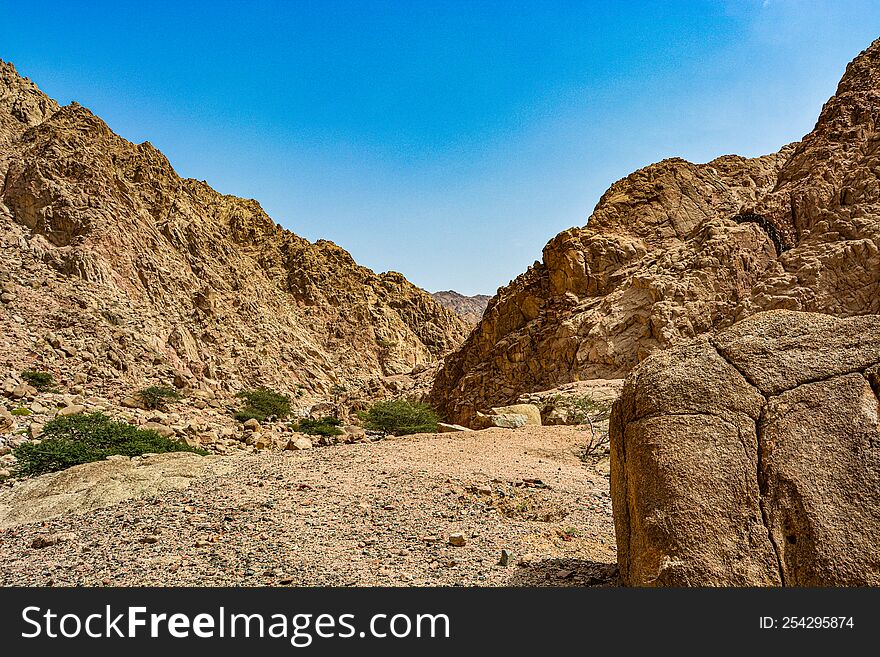 Canyon Of The Yellow Sandy Mountains In The Desert Of Jordan Near The City Of Aqaba, On The Shores Of The Red Sea