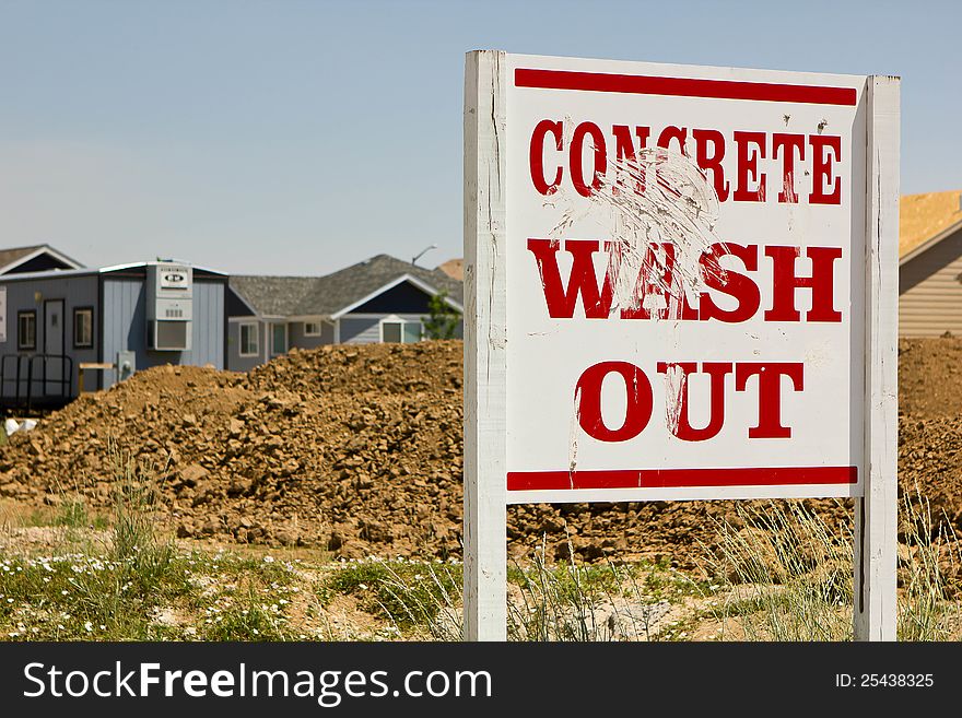 A sign at a construction site for new homes shows where to wash out concrete. A sign at a construction site for new homes shows where to wash out concrete