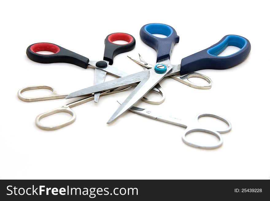 Different set of shears on one meeting, scissors isolated on white background