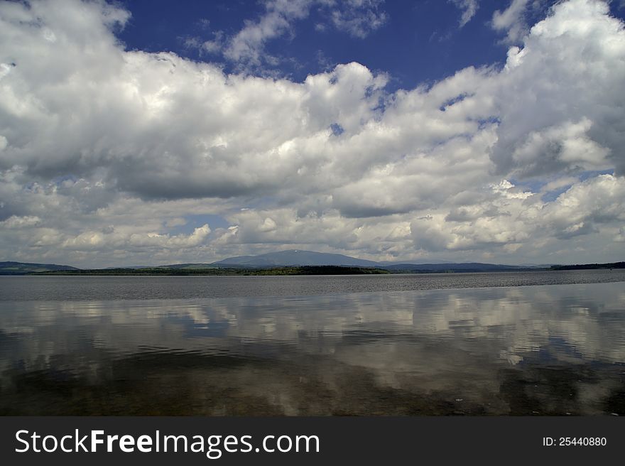 Reflections water sky clouds lake. Reflections water sky clouds lake