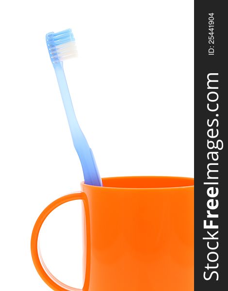 Blue toothbrush and cup on white background