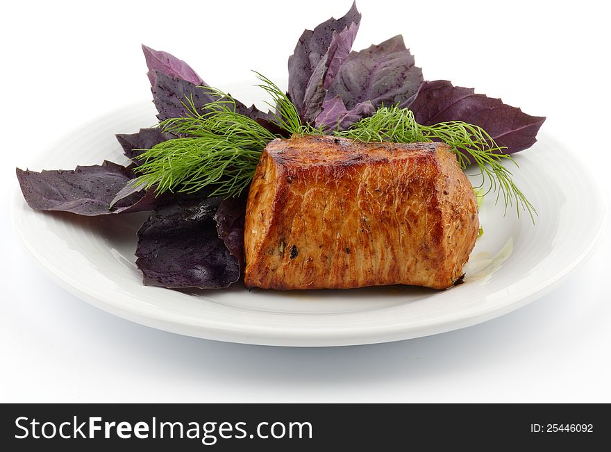 Spicy Roast Pork tenderloin with basil and dill closeup on white background