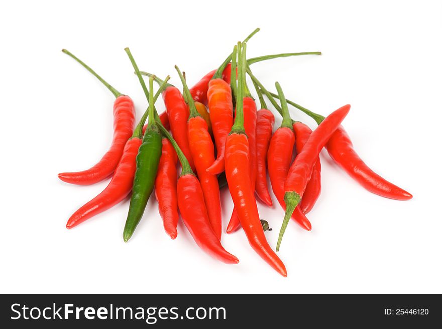 Arrangement of one green and heap red chili peppers isolated in white background. Arrangement of one green and heap red chili peppers isolated in white background