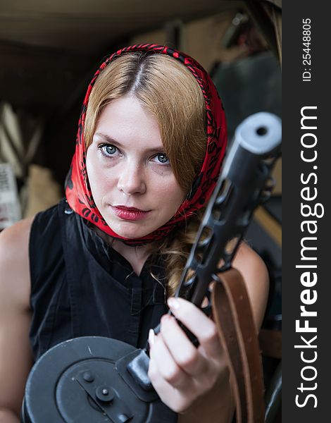 The girl sitting in a car with a rifle in his hand. The girl sitting in a car with a rifle in his hand.