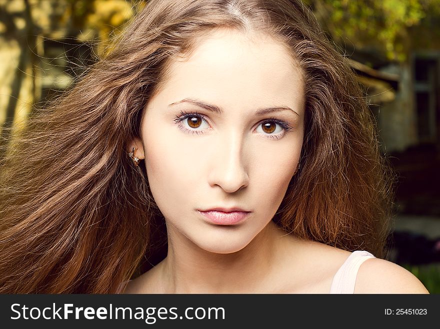 Fashion portrait of beautiful woman posing on bright background