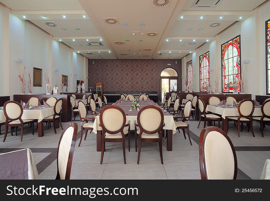 Interior of a hotel restaurant during day. Interior of a hotel restaurant during day.