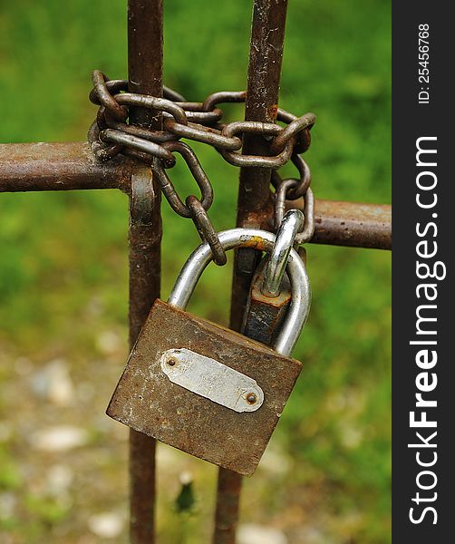 Old rusty lock on a metal gate