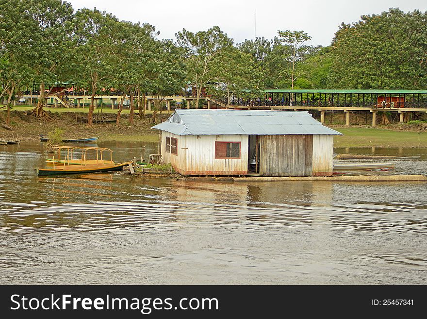 A small wooden house on the waters of the river. A small wooden house on the waters of the river