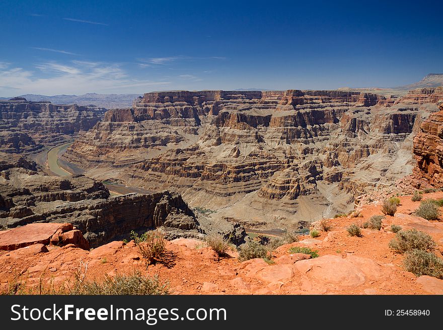 The View of the Grand Canyon from the West Rim called Guano Point with Colorado River in the background with Blue skys. The View of the Grand Canyon from the West Rim called Guano Point with Colorado River in the background with Blue skys
