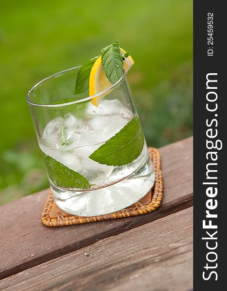 Rum cocktail in the garden on an wooden table in natural light