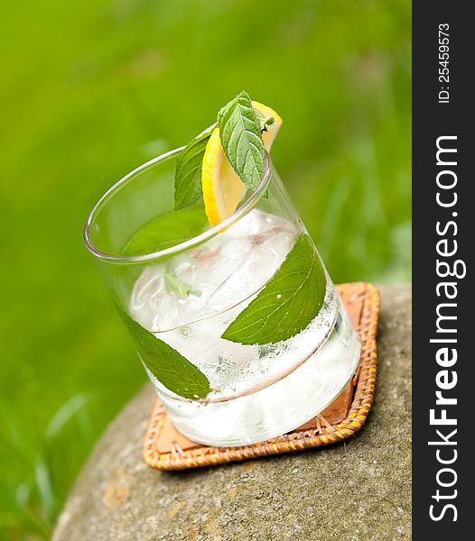 Rum cocktail on a stone in the garden in natural light