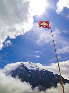 A National Flag Of Switzerland With Mt.Wetterhorn Stock Photos