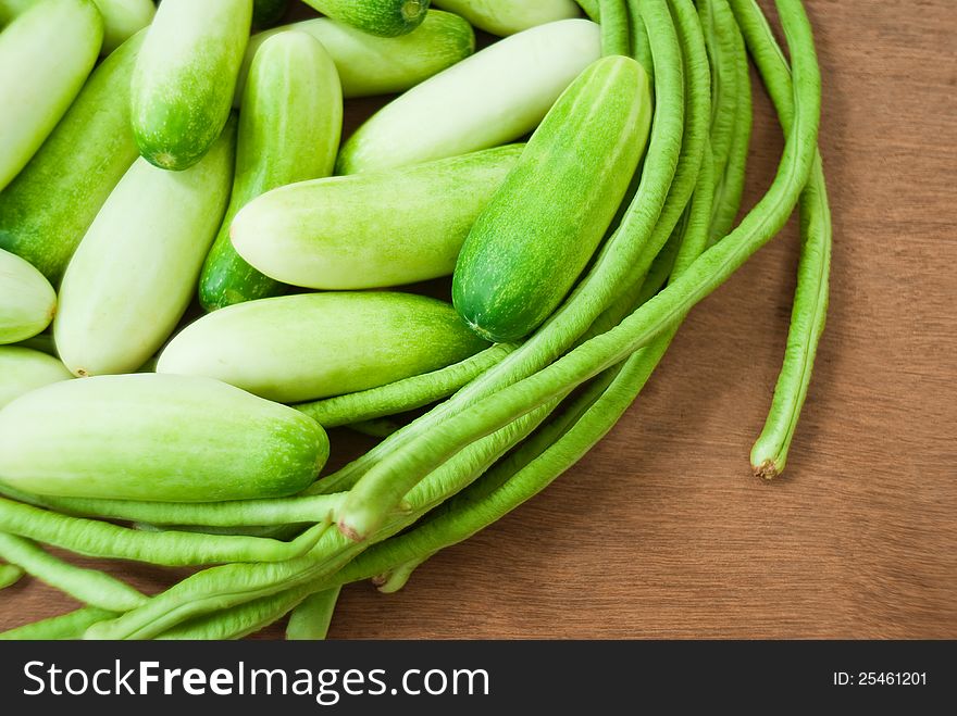 CUCUMBERS AND GREEN BEANS ON PLYWOOD. CUCUMBERS AND GREEN BEANS ON PLYWOOD