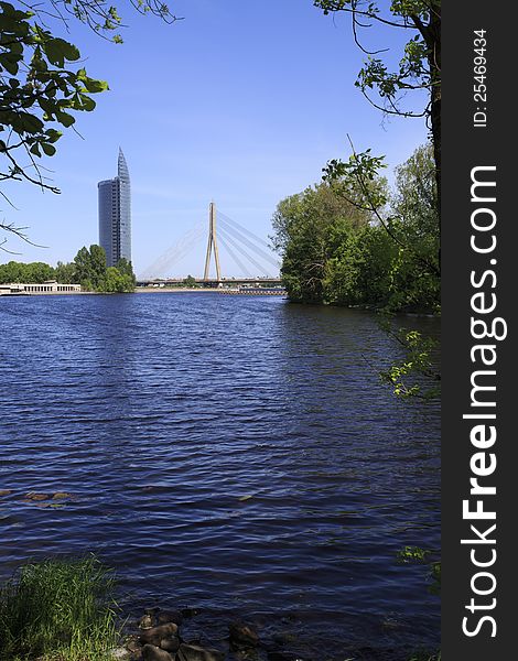 Vansu Tilts Riga bridge with modern building and lake