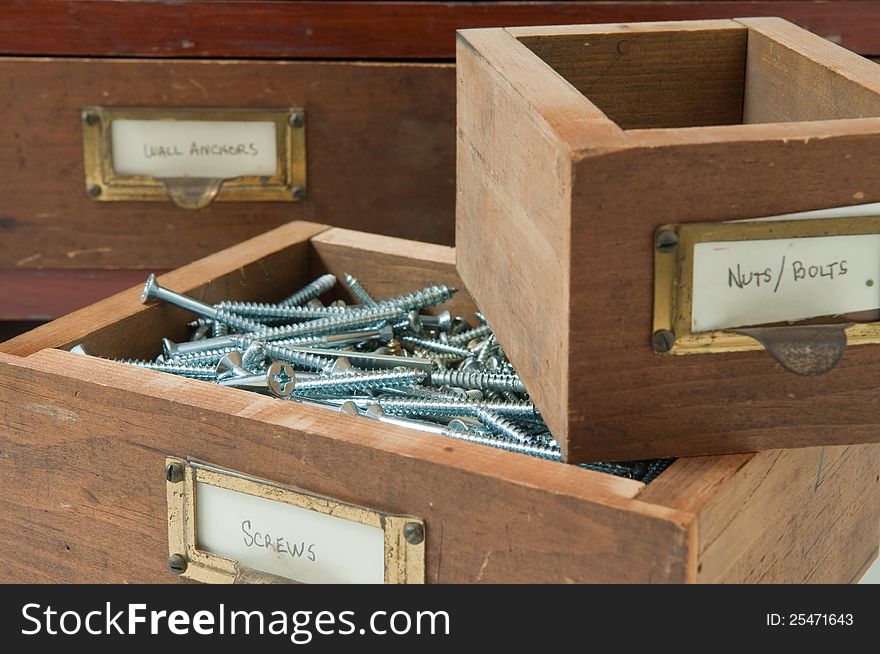 Antique wooden boxes hold various typs of small hardware. Antique wooden boxes hold various typs of small hardware