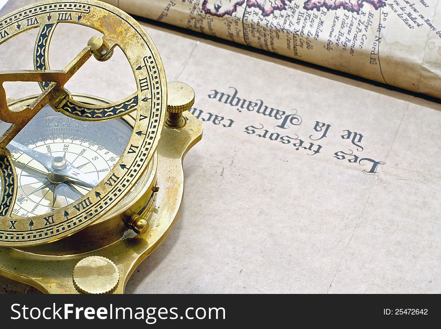 A antique compass on an old map