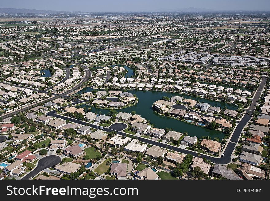 Aerial of suburban neighborhood with man made lake. Aerial of suburban neighborhood with man made lake