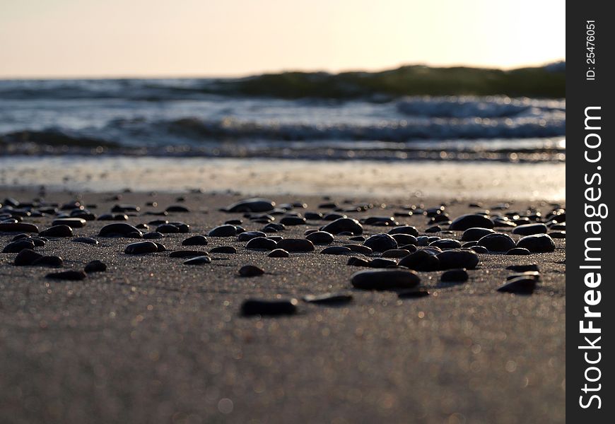 Pebbles on the sea shore with blurred background