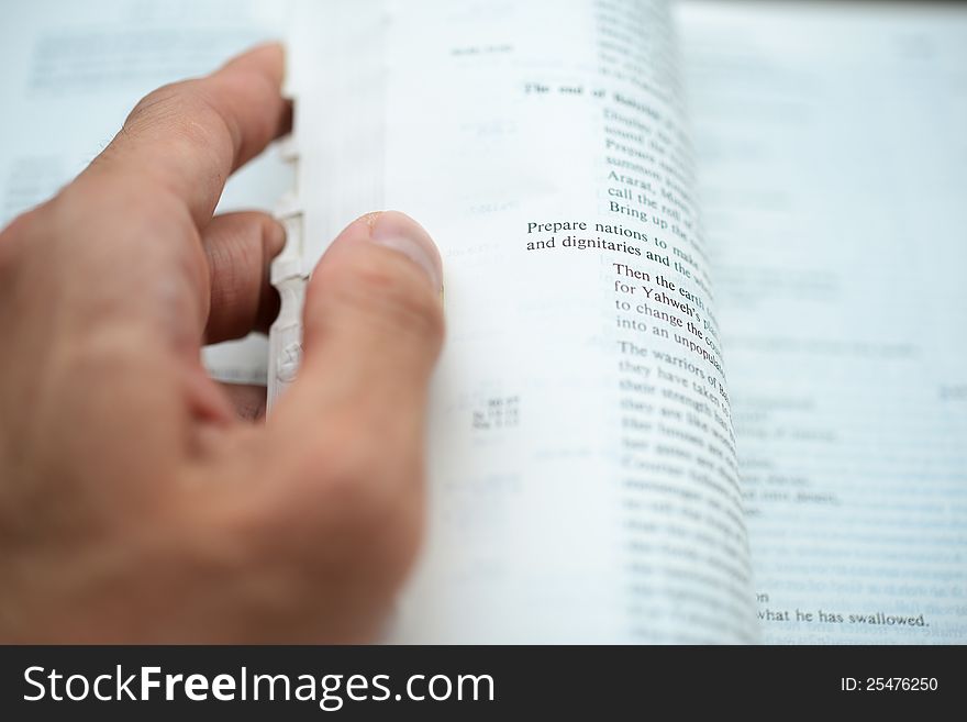 Hand Flipping The Bible Pages With Shallow DOF
