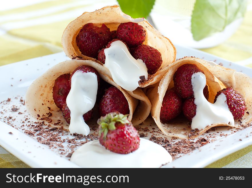 Fresh pancakes. Strawberries and cream inside