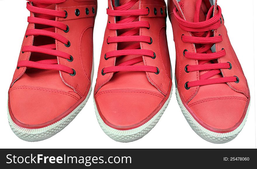 Three casual red leather shoes isolated on white background. Three casual red leather shoes isolated on white background.