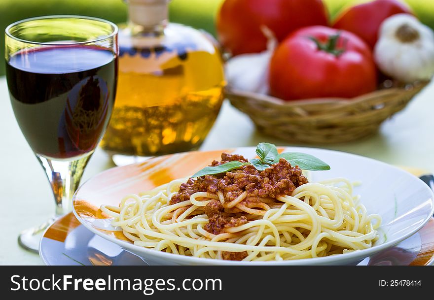 Spaghetti bolognese garnished with tomato and basil