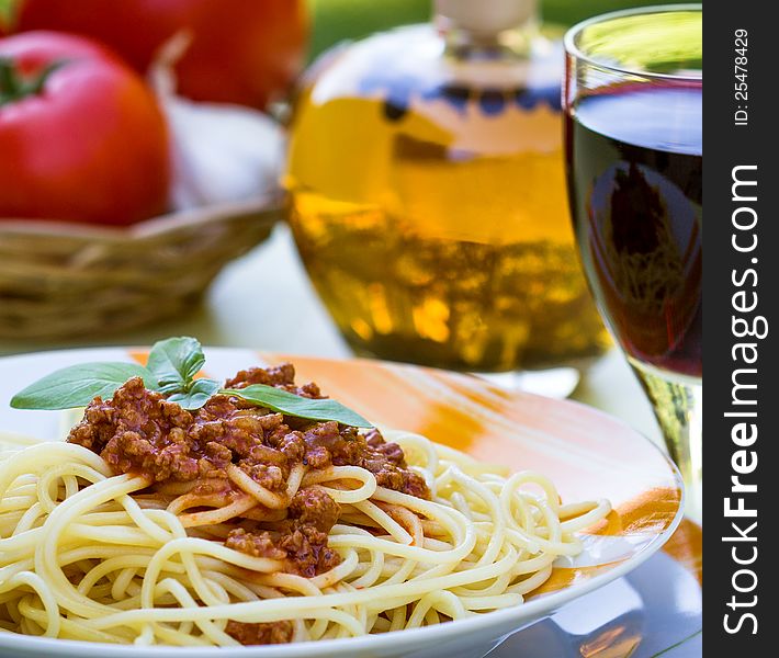 Spaghetti bolognese with glass of vine